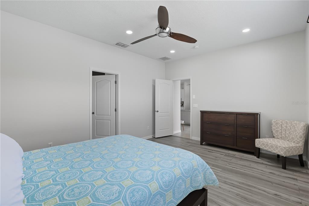 12154 Beach Fern Road Orlando, FL 32824 - Photo 15 of 34 a bedroom with a bed and a chair