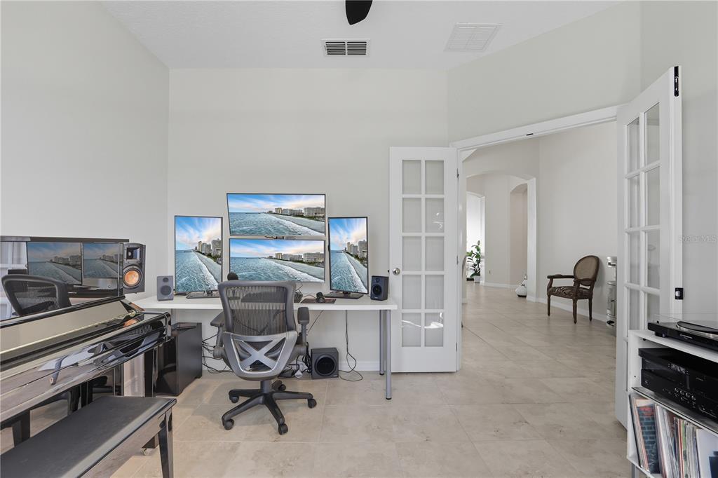 12154 Beach Fern Road Orlando, FL 32824 - Photo 17 of 34 a view of a workspace with furniture and a kitchen
