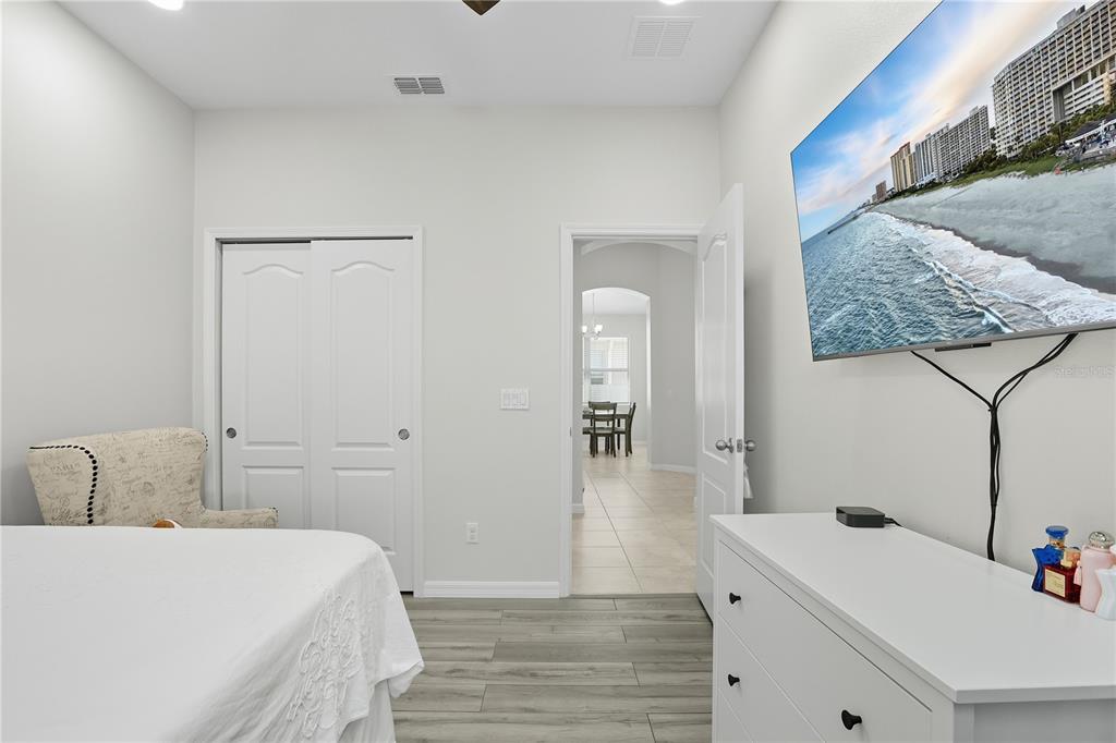 12154 Beach Fern Road Orlando, FL 32824 - Photo 23 of 34 a bedroom with a bed and cabinets