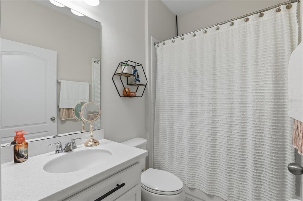 12154 Beach Fern Road Orlando, FL 32824 - Photo 26 of 34 a bathroom with a toilet sink and mirror