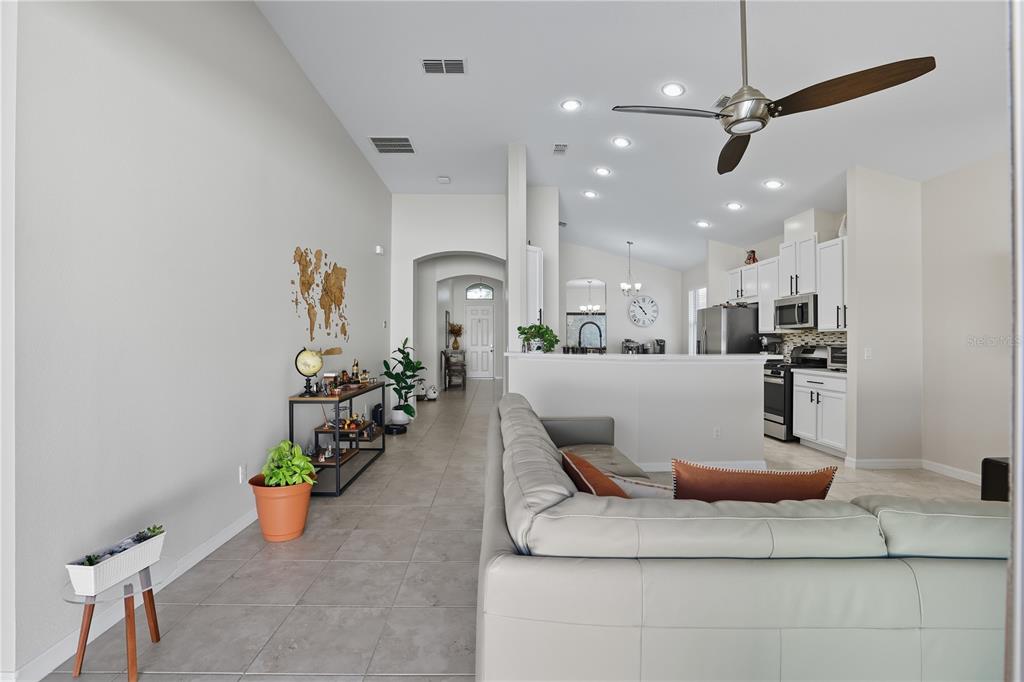 12154 Beach Fern Road Orlando, FL 32824 - Photo 8 of 34 a living room with furniture and a dining table