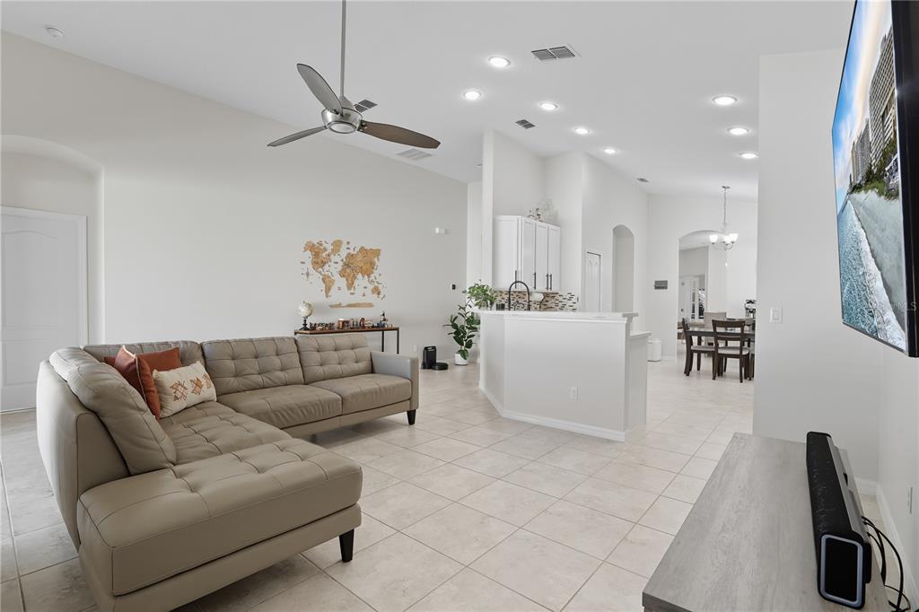 12154 Beach Fern Road Orlando, FL 32824 - Photo 9 of 34 a living room with furniture and a chandelier