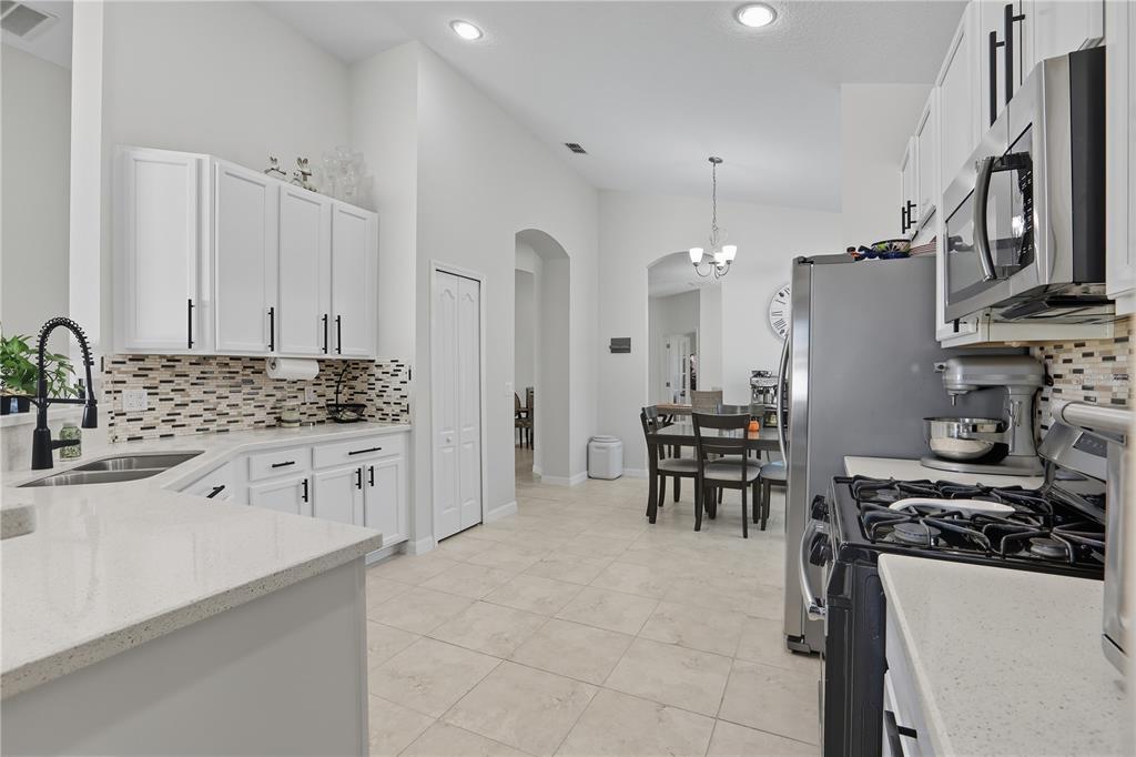 12154 Beach Fern Road Orlando, FL 32824 - Photo 10 of 34 a kitchen with granite countertop a sink stove and cabinets