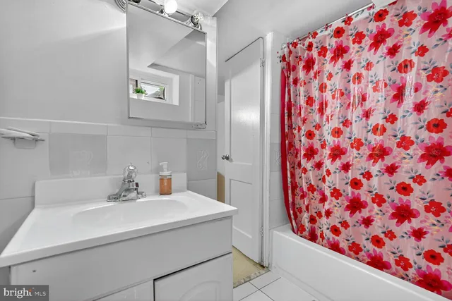 a bathroom with a sink and mirror with toilet