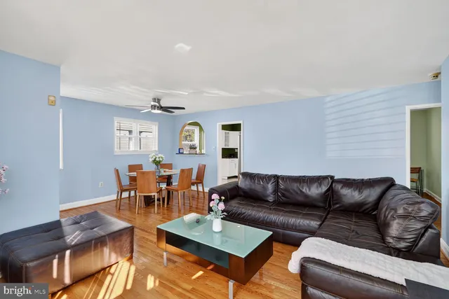 a living room with furniture kitchen view and a dining table