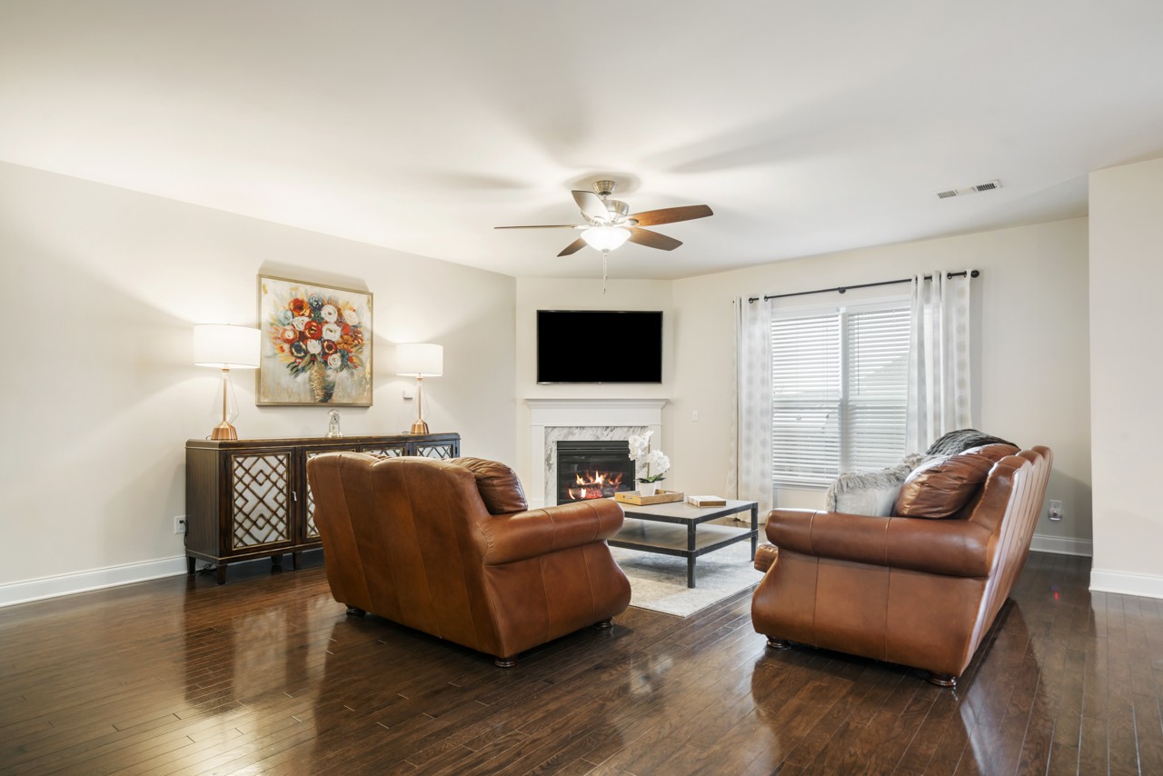 2995 Liverpool Drive Spring Hill, TN 37174 - Photo 14 of 37 a living room with furniture fireplace and a flat screen tv
