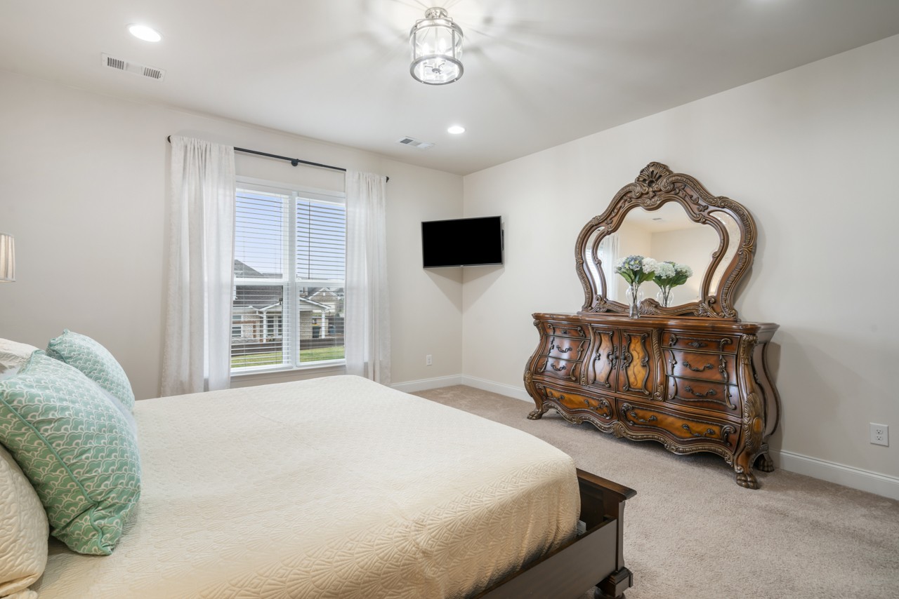 2995 Liverpool Drive Spring Hill, TN 37174 - Photo 18 of 37 a bedroom with a bed window and a flat screen tv