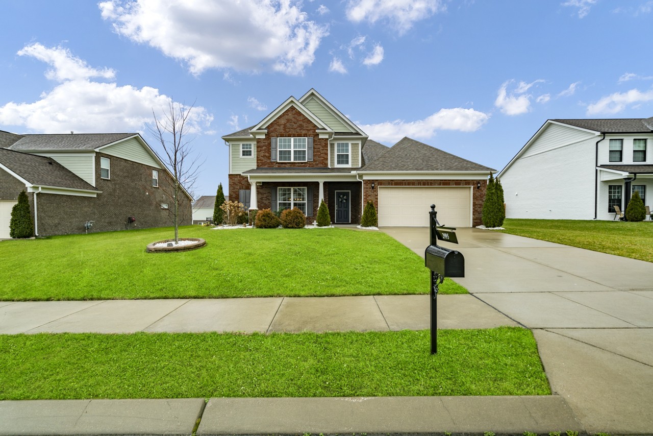 2995 Liverpool Drive Spring Hill, TN 37174 - Photo 2 of 37 a front view of a house with a garden and yard