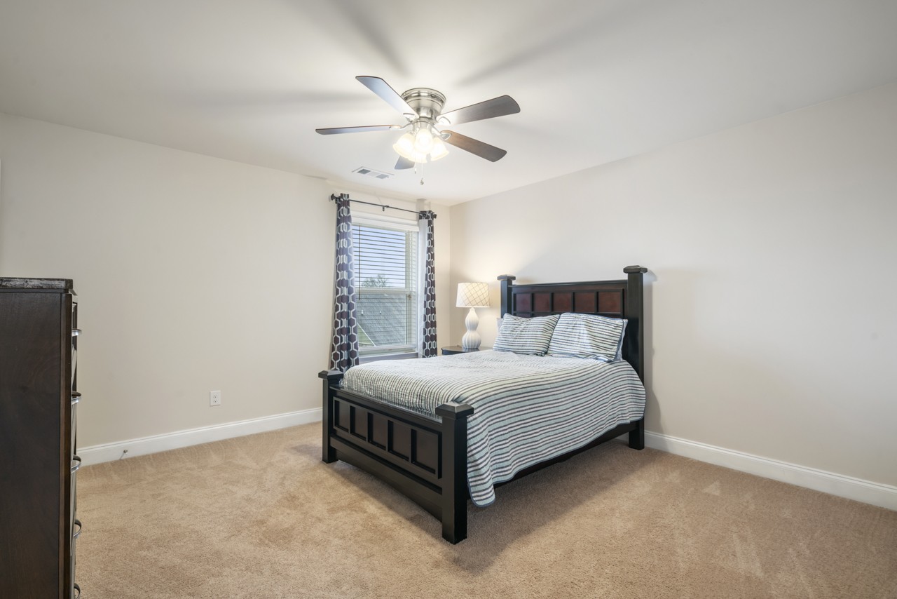 2995 Liverpool Drive Spring Hill, TN 37174 - Photo 21 of 37 a large bed sitting in a room next to a lamp