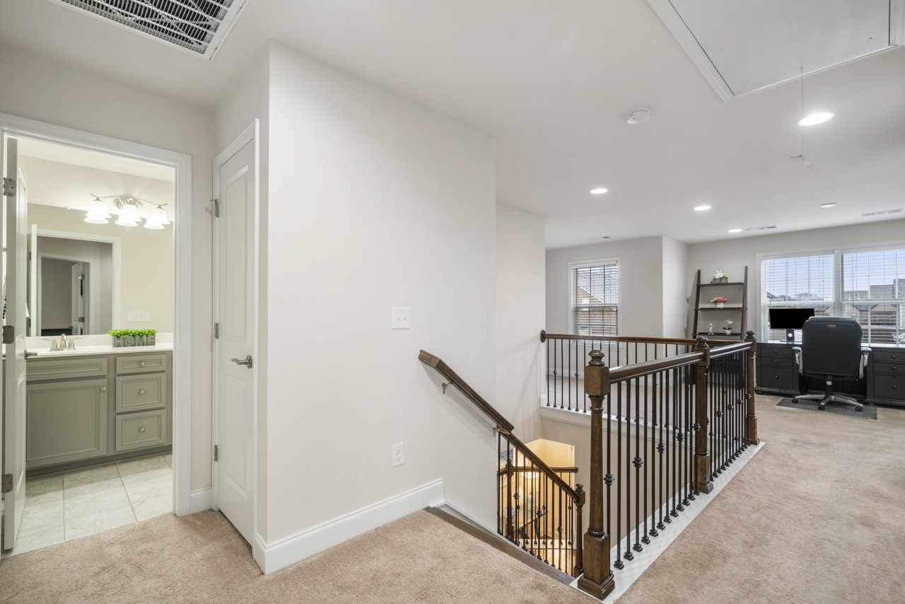 2995 Liverpool Drive Spring Hill, TN 37174 - Photo 22 of 37 a view of a hallway with workspace and livingroom with furniture