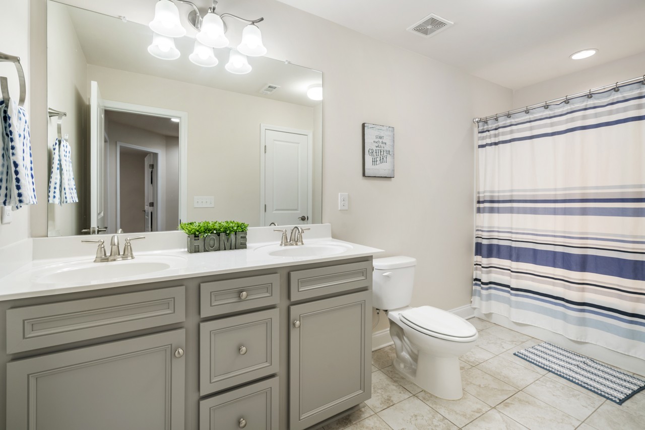 2995 Liverpool Drive Spring Hill, TN 37174 - Photo 23 of 37 a bathroom with a sink a toilet and mirror