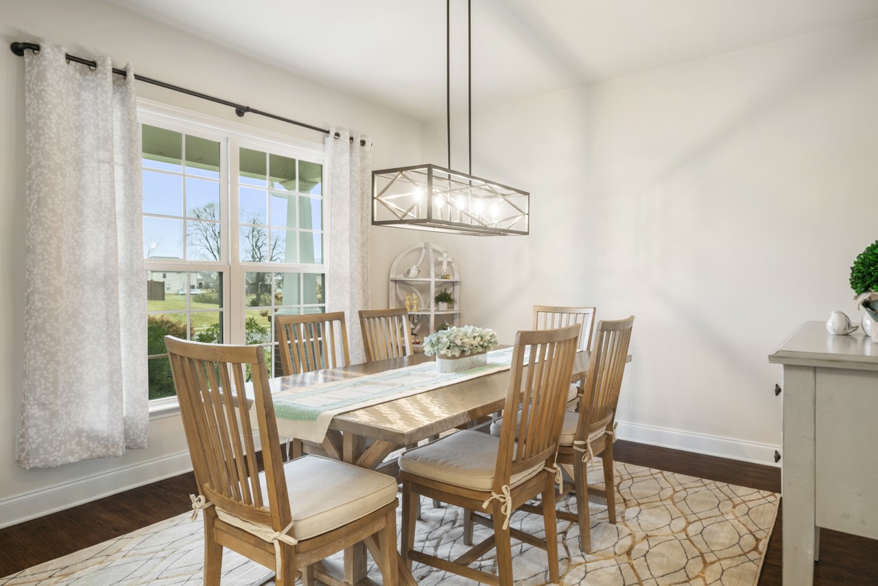 2995 Liverpool Drive Spring Hill, TN 37174 - Photo 4 of 37 a dining room with furniture a chandelier and wooden floor