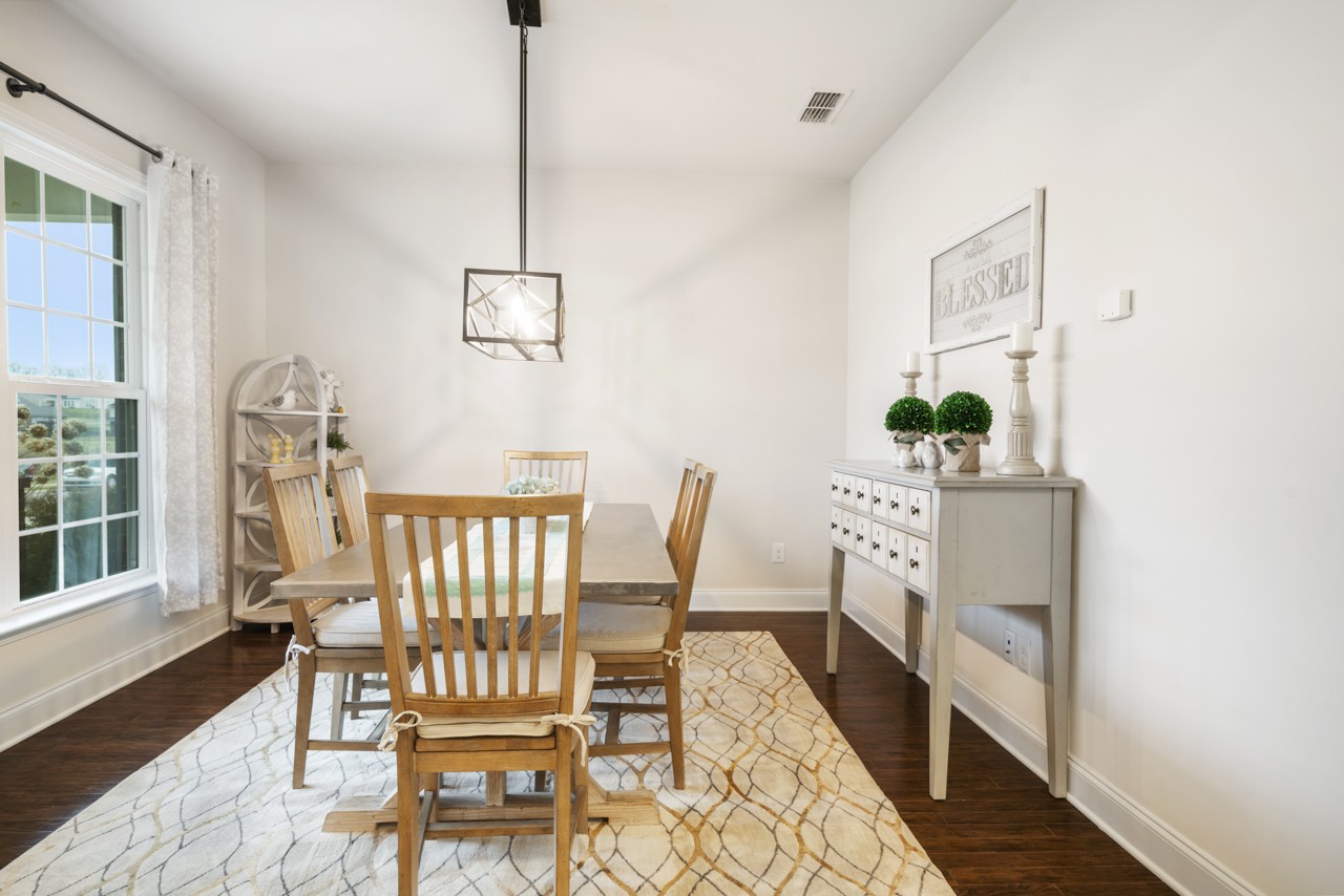 2995 Liverpool Drive Spring Hill, TN 37174 - Photo 5 of 37 a view of a dining room with furniture and wooden floor
