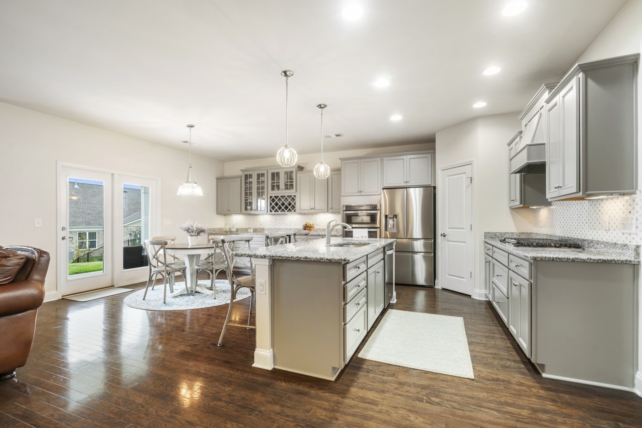 2995 Liverpool Drive Spring Hill, TN 37174 - Photo 7 of 37 a large kitchen with kitchen island lots of counter space a sink appliances and a living room view