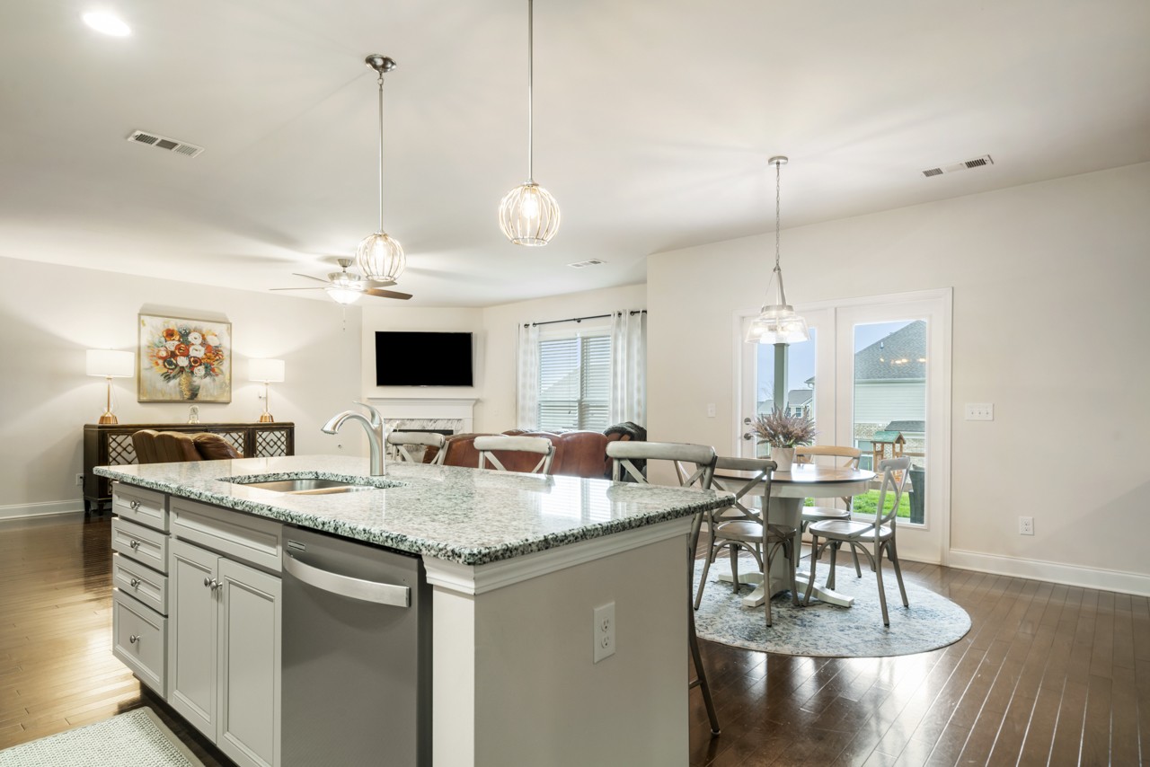 2995 Liverpool Drive Spring Hill, TN 37174 - Photo 8 of 37 a view of a dining room and livingroom with furniture wooden floor a chandelier