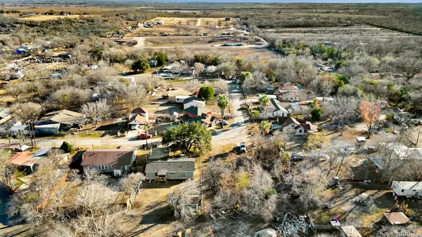 an aerial view of residential houses with outdoor space