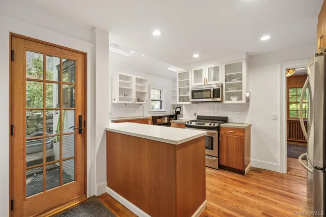 a kitchen with stainless steel appliances granite countertop a stove top oven and sink