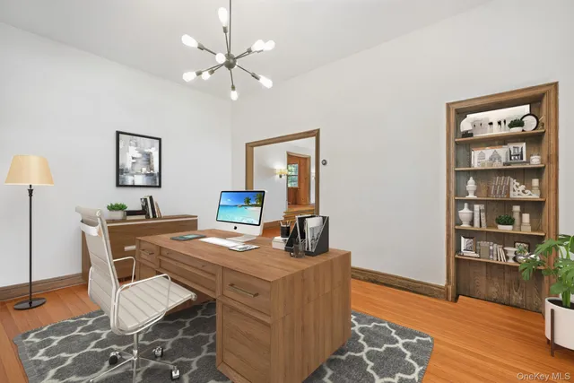 a view of a workspace with furniture and wooden floor