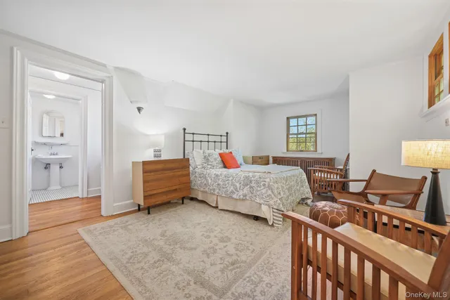 a bedroom with furniture and wooden floor