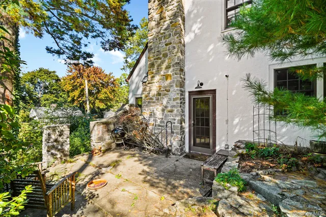 a view of a house with a tree in the background