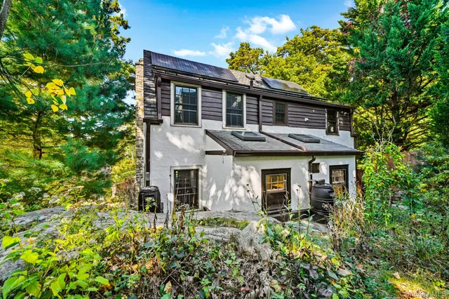 front view of a house with a tree