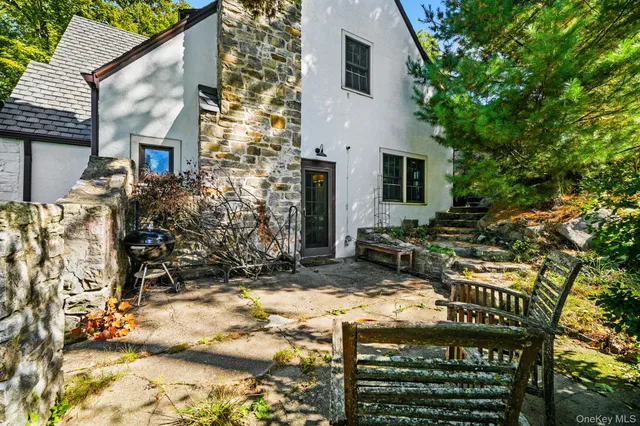 a view of a house with a yard and sitting area