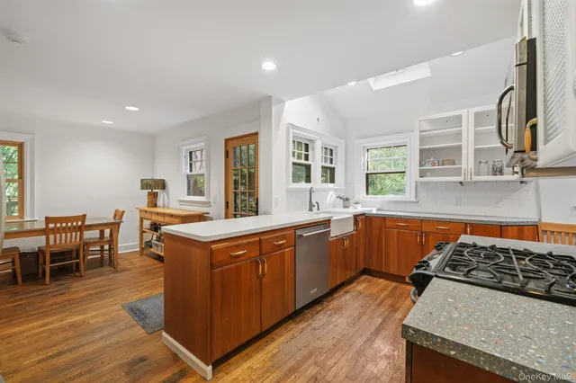 a kitchen with stainless steel appliances granite countertop a stove and a sink