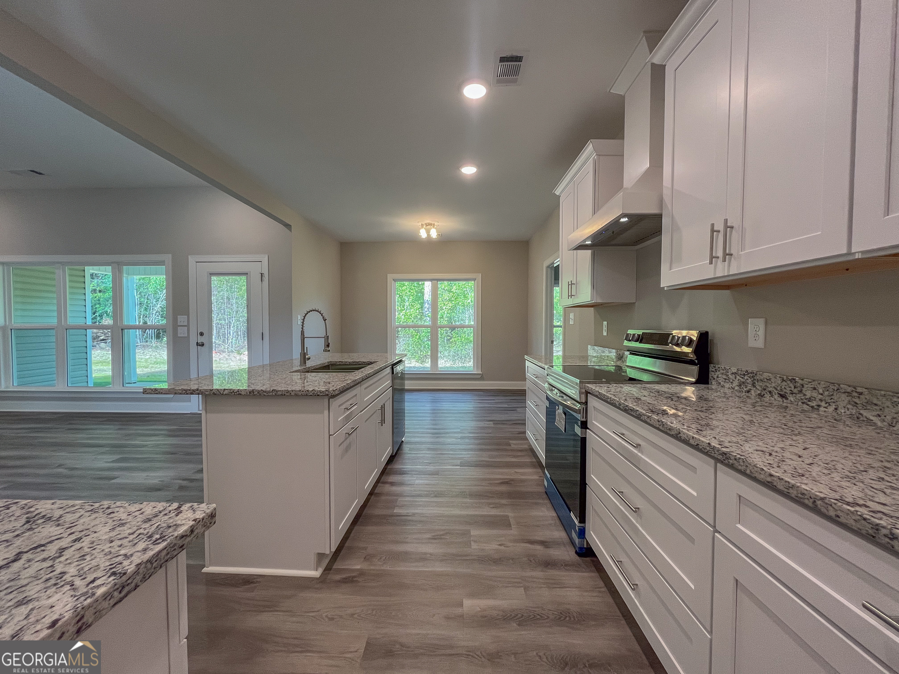 711 Flanders Lane Dublin, GA 31021 - Photo 15 of 49 a large kitchen with stainless steel appliances granite countertop a stove a sink and a refrigerator
