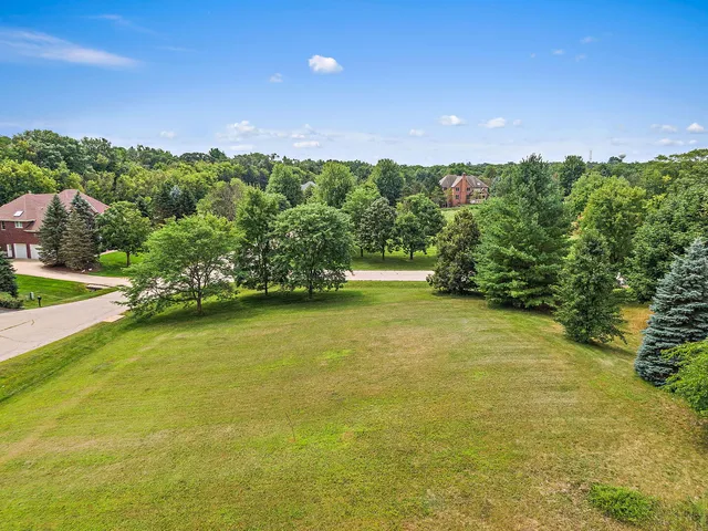 a view of a yard with a house in the background