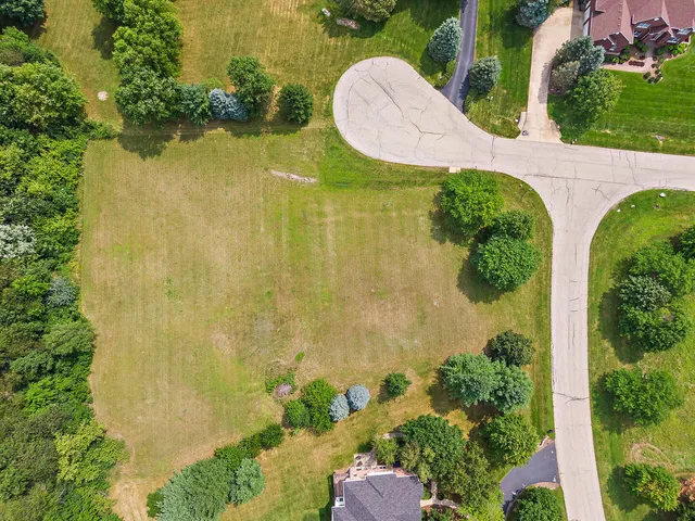 an aerial view of a residential houses with swimming pool and outdoor space