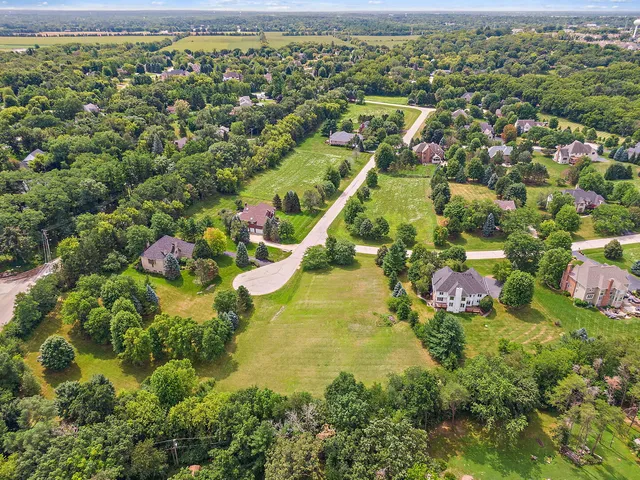 an aerial view of residential house with outdoor space and swimming pool