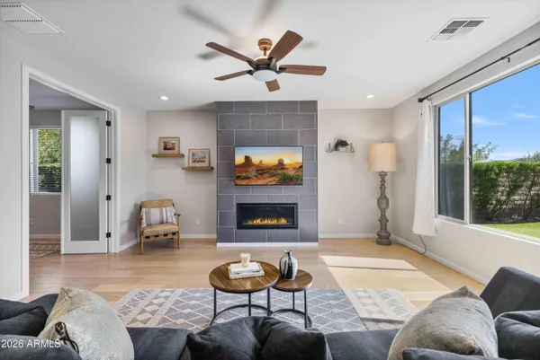 a kitchen with stainless steel appliances granite countertop a sink a stove a refrigerator a kitchen island with chairs and refrigerator