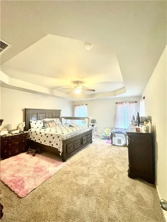 a bed room with a bed and a chair