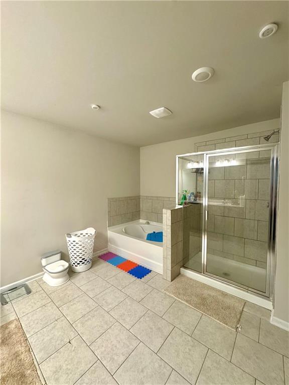 2188 Justify Lane, Unit 40 Lithonia, GA 30058 - Photo 12 of 21 a bathroom with a bathtub and a shower