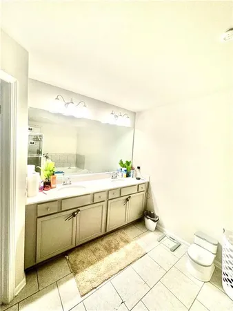 a large bathroom with a sink mirror and a bathtub