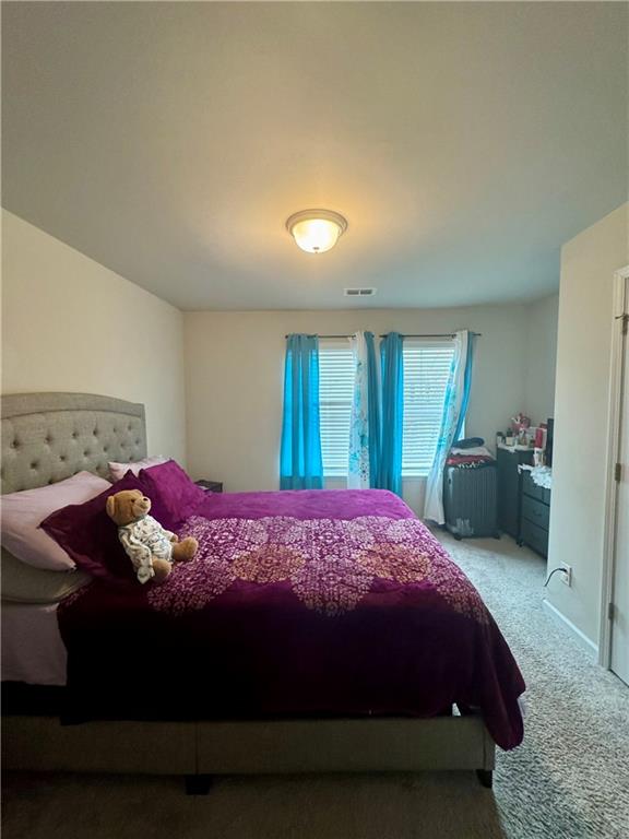 2188 Justify Lane, Unit 40 Lithonia, GA 30058 - Photo 18 of 21 a bedroom with a bed dresser and a window