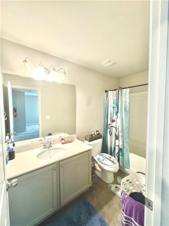 2188 Justify Lane, Unit 40 Lithonia, GA 30058 - Photo 19 of 21 a bathroom with a double vanity sink mirror and toilet