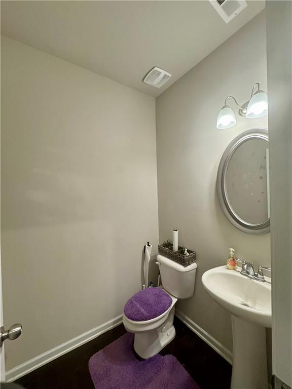 2188 Justify Lane, Unit 40 Lithonia, GA 30058 - Photo 6 of 21 a bathroom with a sink a toilet and a mirror