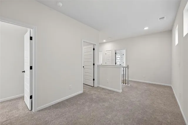 a view of a kitchen with a refrigerator and a sink
