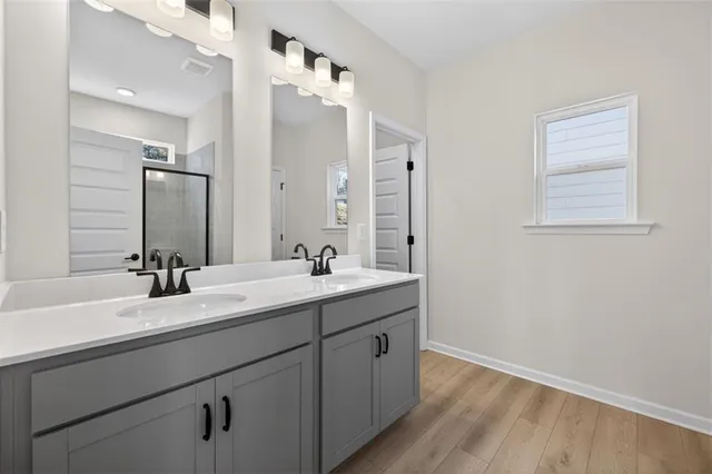 a bathroom with a double vanity sink mirror and