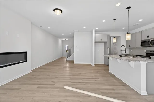 a large kitchen with stainless steel appliances kitchen island a large island in the center