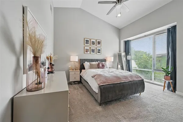 a bedroom with a bed and a large window