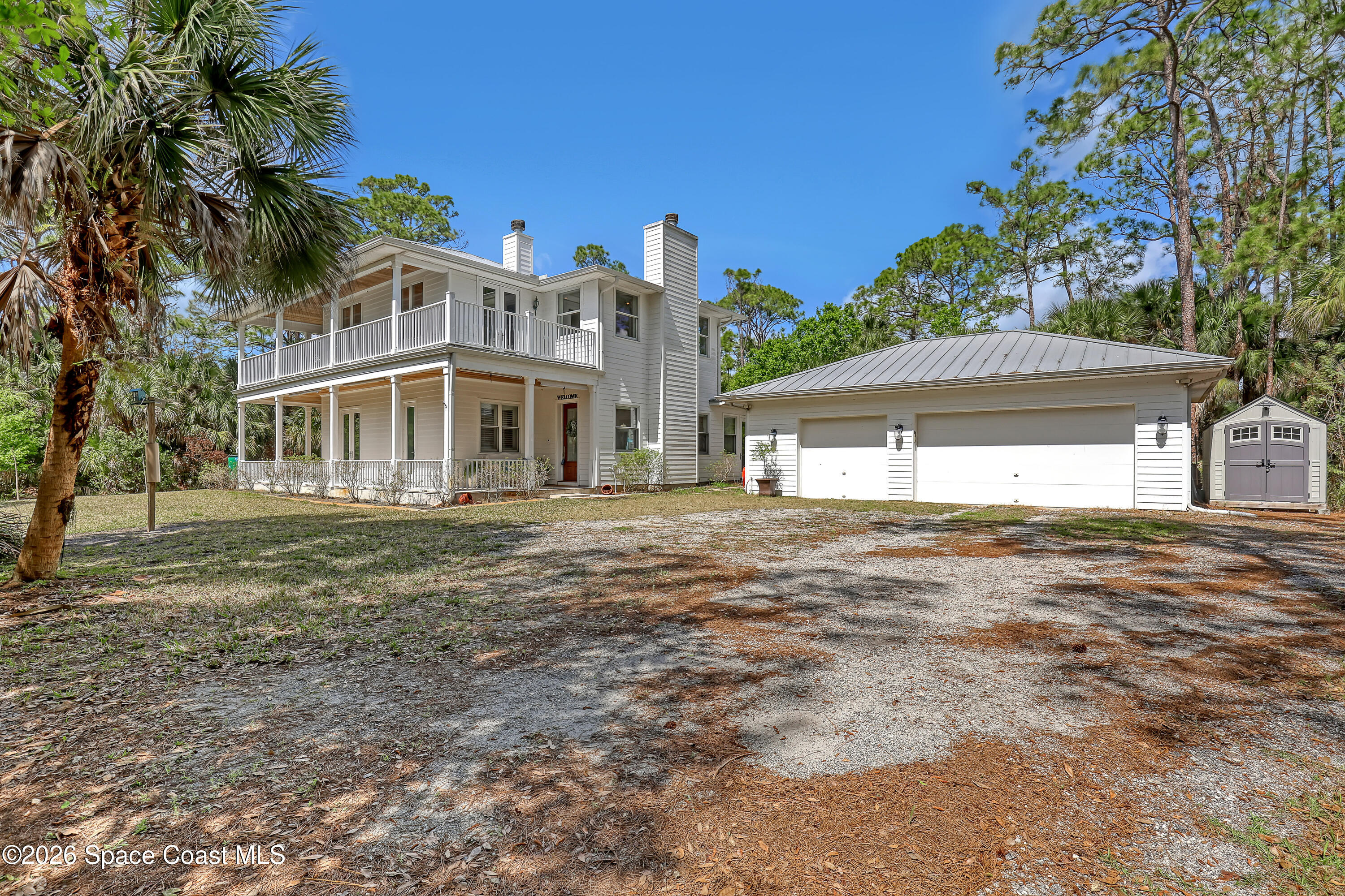 4200 Mustang Road Melbourne, FL 32934 - Photo 1 of 58 a front view of a house with a garden