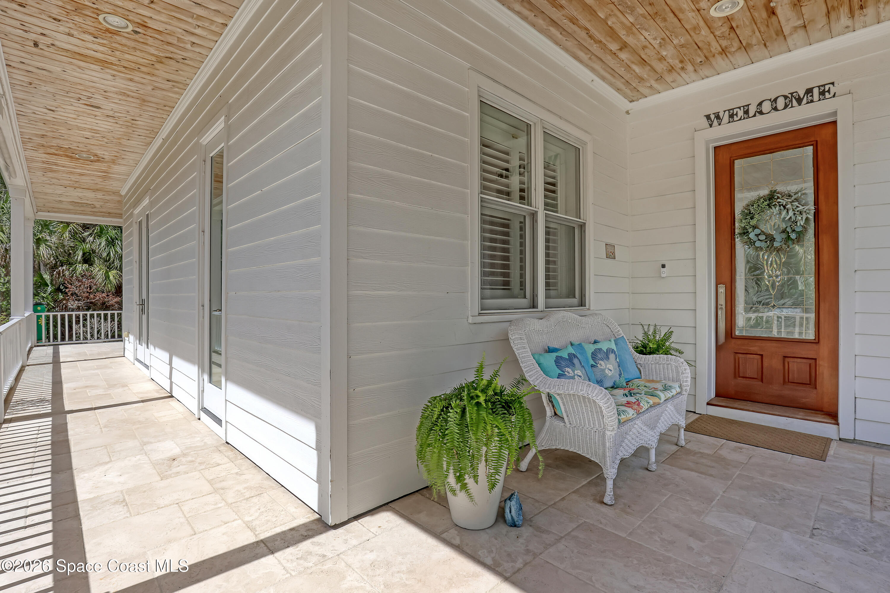 4200 Mustang Road Melbourne, FL 32934 - Photo 12 of 58 a balcony with furniture and a potted plant