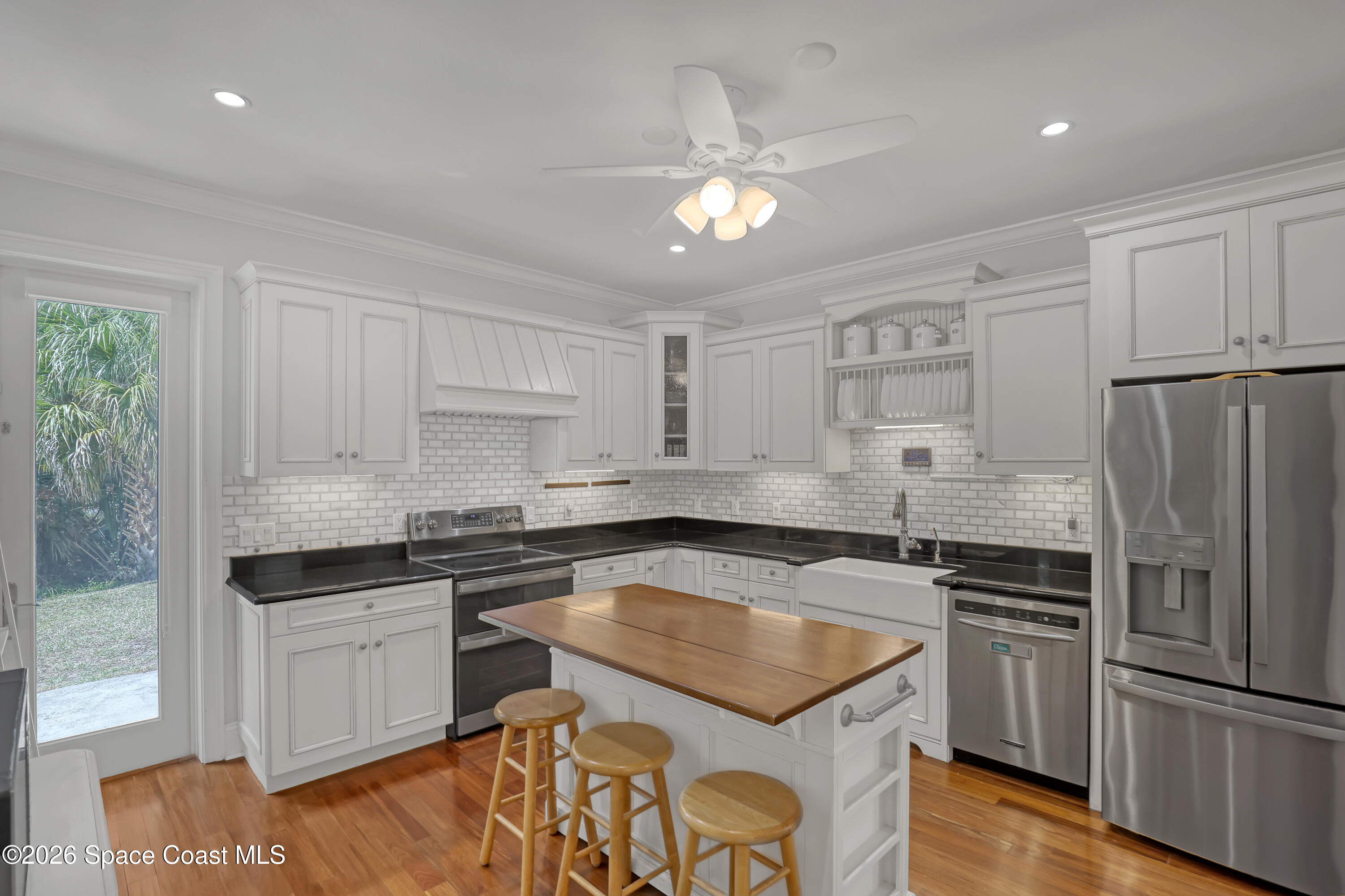 4200 Mustang Road Melbourne, FL 32934 - Photo 20 of 58 a kitchen with granite countertop stainless steel appliances cabinets a sink and a counter space