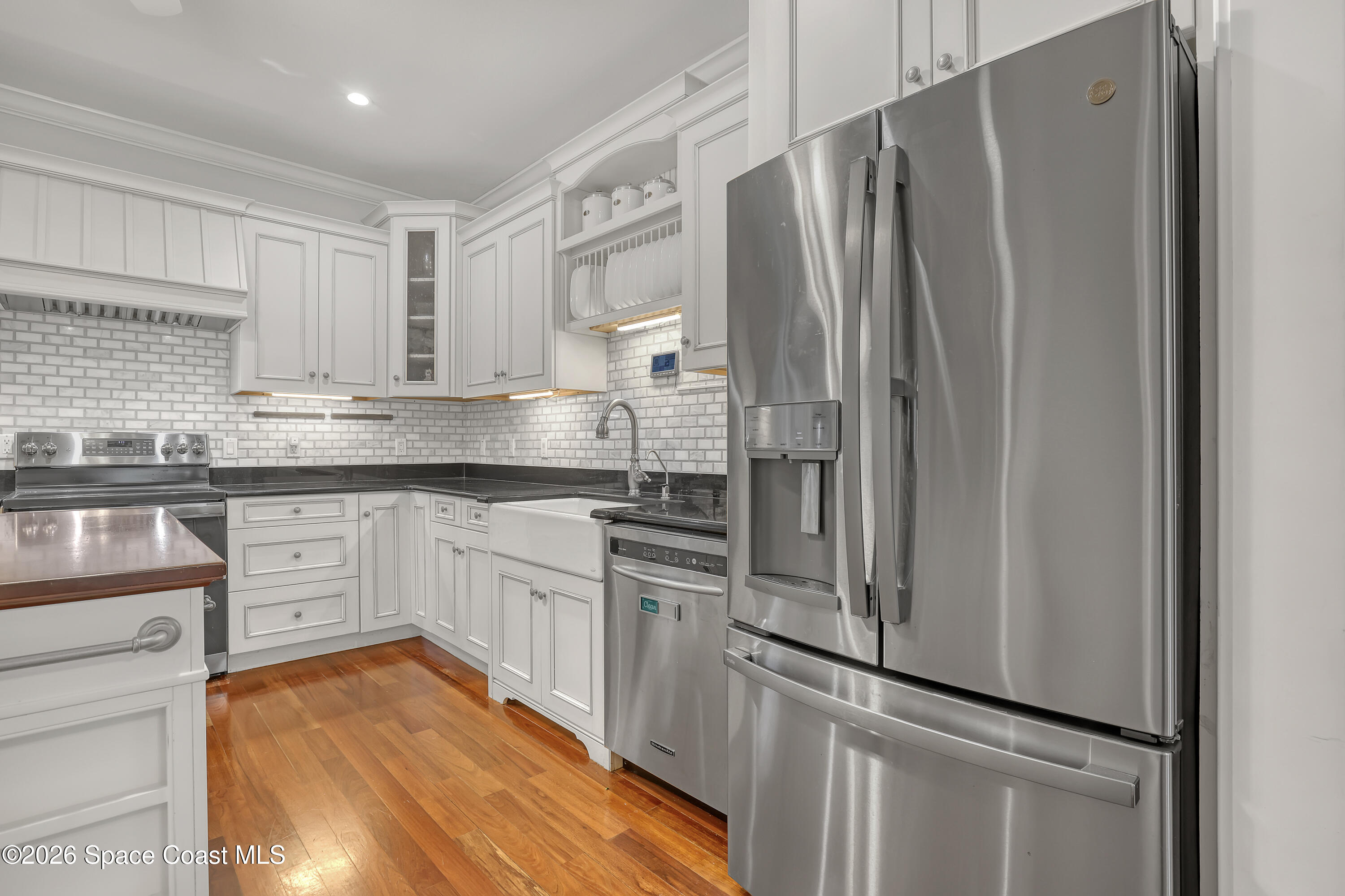 4200 Mustang Road Melbourne, FL 32934 - Photo 21 of 58 a kitchen with stainless steel appliances granite countertop a refrigerator and a stove top oven