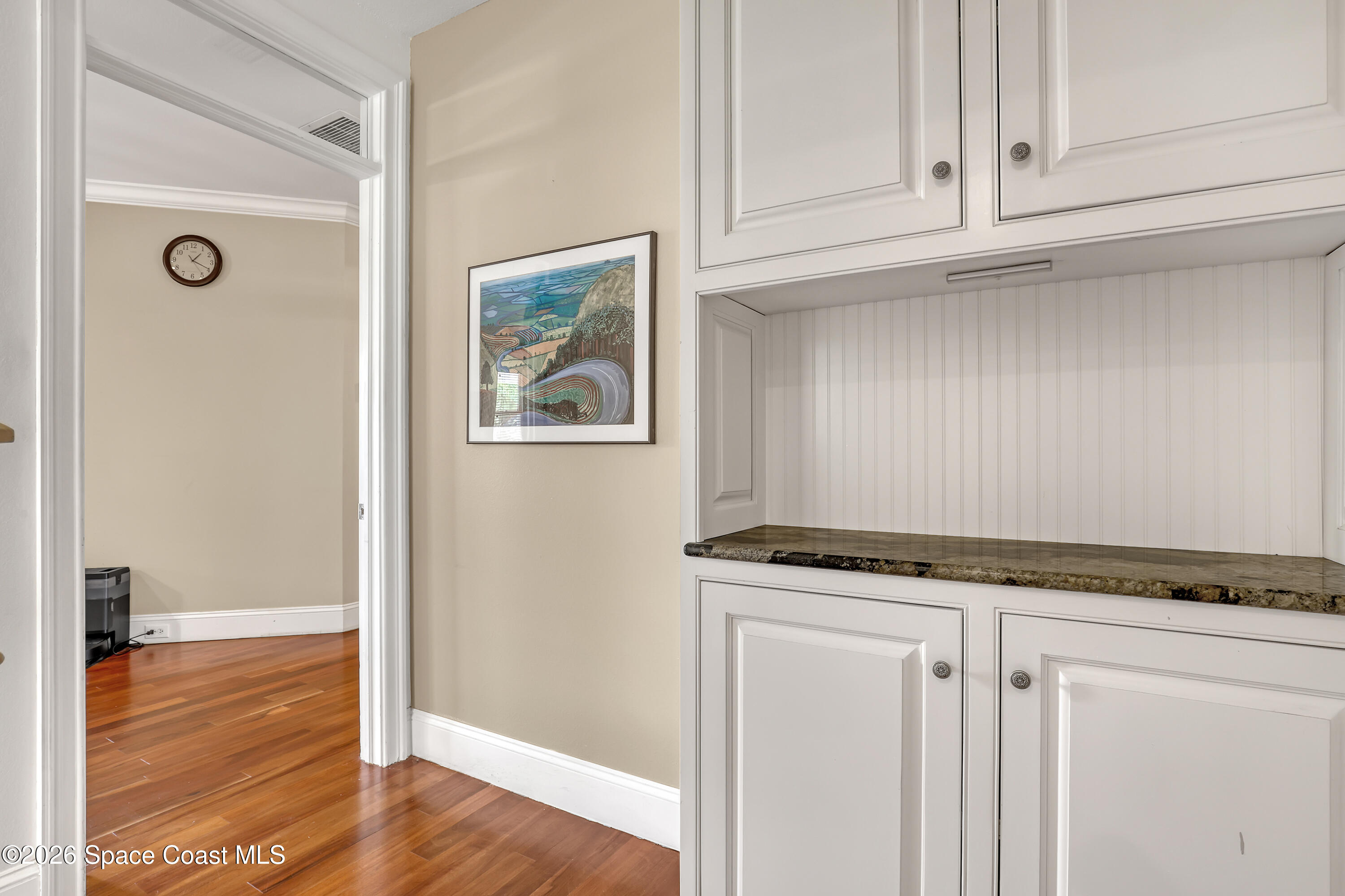 4200 Mustang Road Melbourne, FL 32934 - Photo 24 of 58 a view of a kitchen with granite countertop cabinets and wooden floor