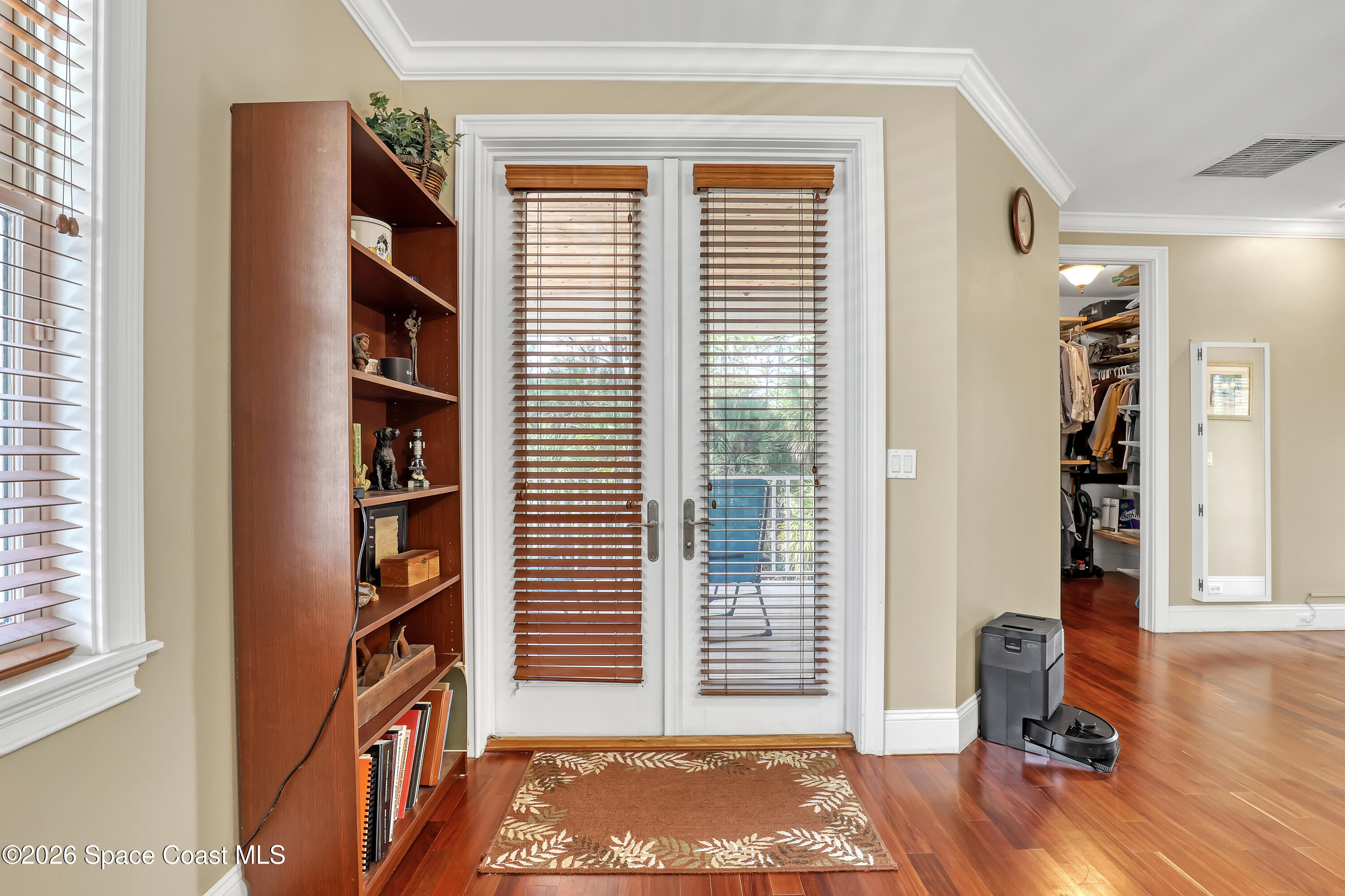 4200 Mustang Road Melbourne, FL 32934 - Photo 37 of 58 a view of room with wooden floor and bookshelf