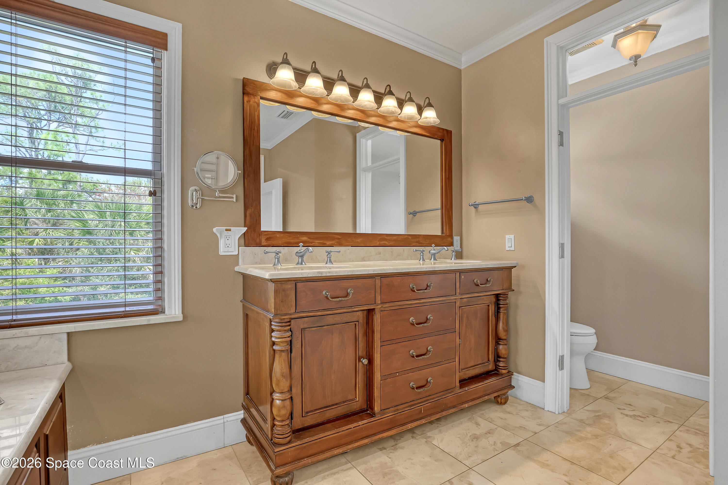4200 Mustang Road Melbourne, FL 32934 - Photo 40 of 58 a spacious bathroom with a granite countertop sink a mirror and a shower