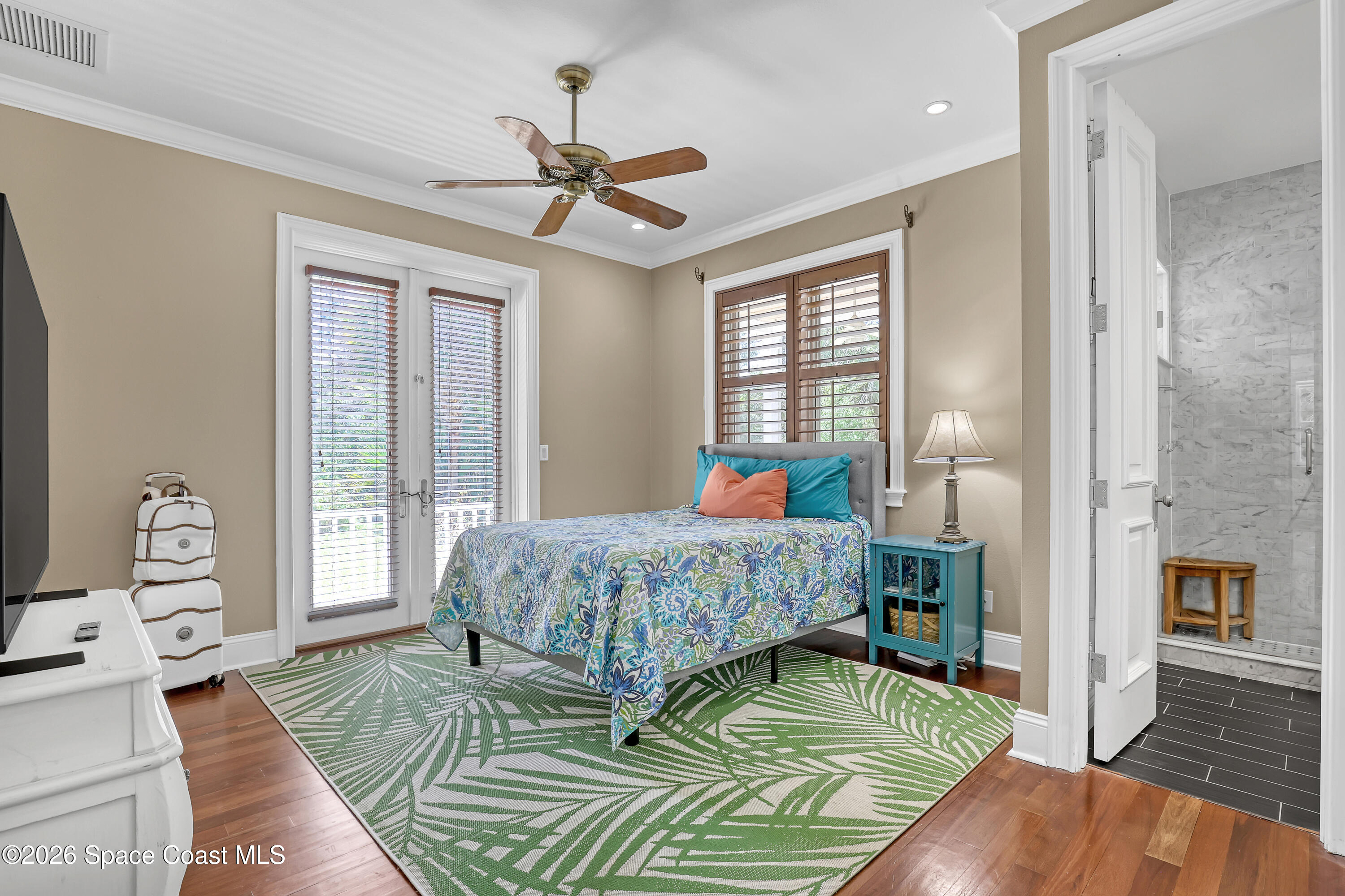 4200 Mustang Road Melbourne, FL 32934 - Photo 41 of 58 a bedroom with a bed and wooden floor